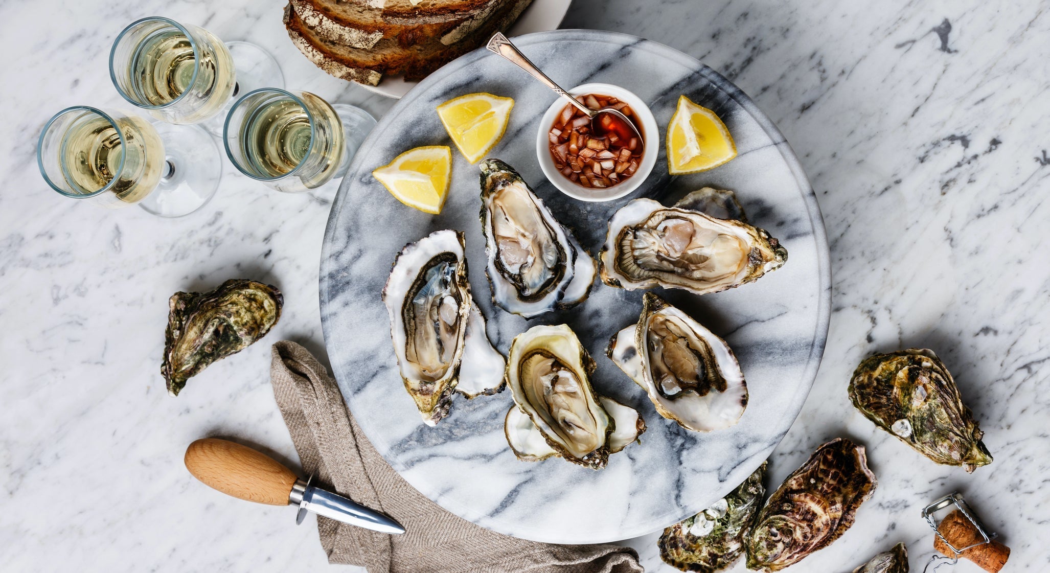 Open-Oysters-with-lemon,-bread,-butter-and-champagne-695621876 1416x2125