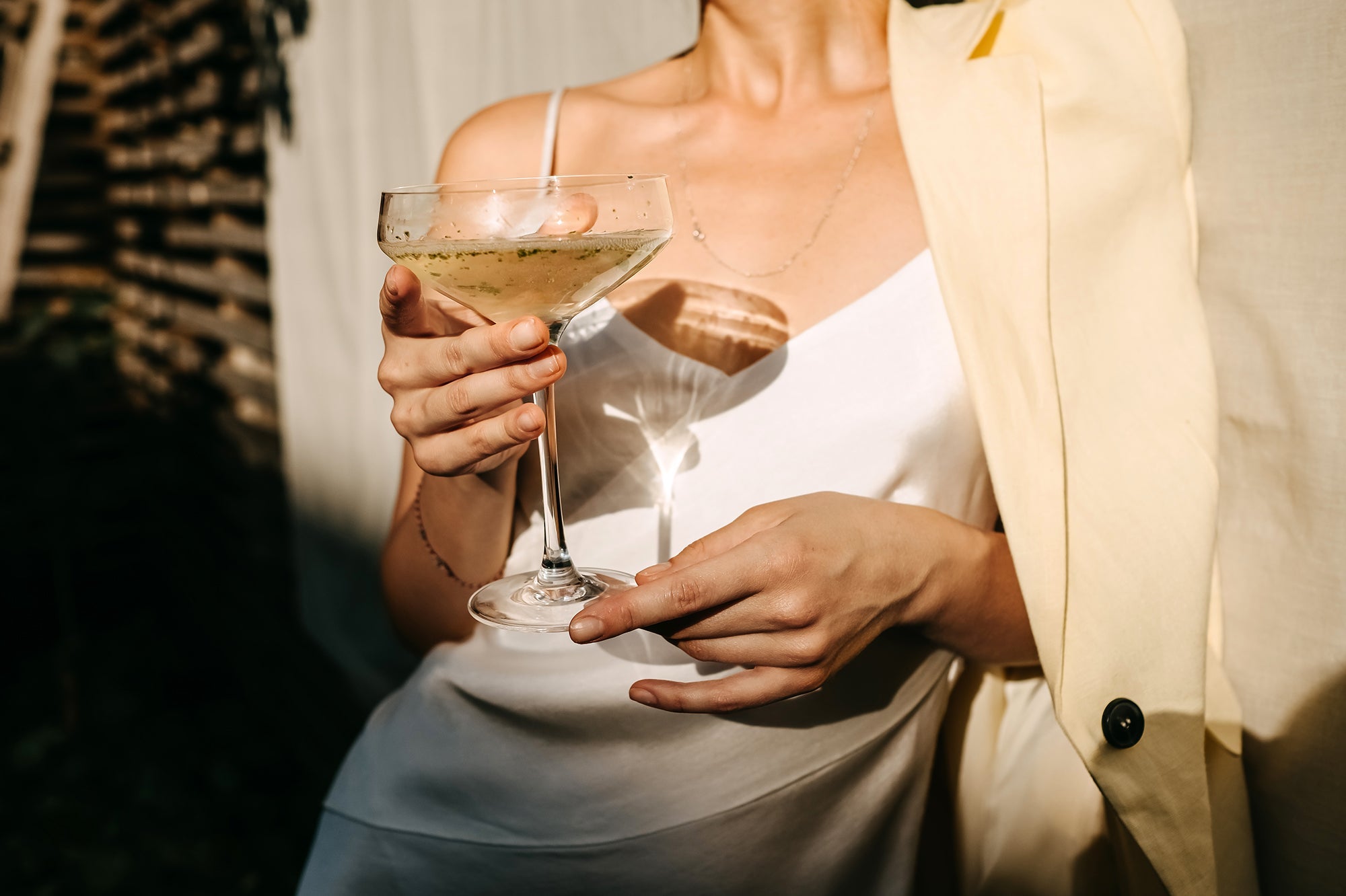 what is champagne: woman holding coupe champagne glass